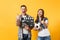 Young excited couple woman man football fans cheer up support team with soccer ball, film making clapperboard isolated