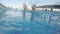 Young excited man swimming in the pool, relaxing, having fun