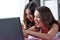 Young excited women online shopping by laptop