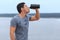 Young exhausted athlete drinking fresh water to refresh during a running trail.