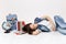 Young exhausted casual woman student in denim clothes resting and sleeping lying near globe, backpack, school books