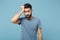 Young exhausted sick man in casual clothes posing isolated on blue wall background, studio portrait. People sincere