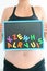 Young expectant mother with magnetic letter blocks trying to choose a name for her baby