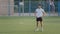 Young experienced coach Indian guy in summer sportswear standing on football field of school stadium prepares for