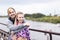 Young extraordinary couple hugging on embankment