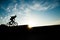 Young extreme man riding bicycle on sunset background with copyspace