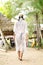 Young faceless latin woman walking on the sand with hat at bocas del toro Panama