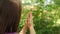 Young faithful Christian woman praying to God Jesus Christ in nature