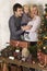 Young family admiring a Christmas tree and gifts