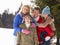 Young Family In Alpine Snow Scene