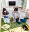 Young family assembling furniture at new house