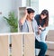 Young family assembling furniture at new house