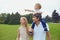 Young family with boy strolling in park