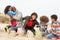 Young Family Building Sandcastle On Beach Holiday