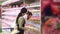 Young family buying eggs at the grocery store. Slow motion. Portrait.