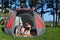 Young family camping in a tent outdoors