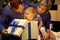 Young family celebrating Christmas at home. father and mother give a child present