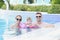 Young family with child in circle in pool on vacation