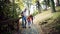 A young family with children walking in park in autumn. Slow motion.