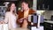 Young family couple looking at kitchen tabletop in furniture workshop