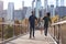 Young family with daughter taking a walk on footbridge