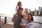 Young family with daughters standing on quayside, close up