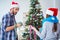 The young family decorating christmas tree on happy occasion