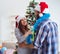 Young family decorating christmas tree on happy occasion