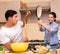 Young family doing funny fight at kitchen