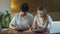 Young family doing paperwork at home. Young couple looking worried sitting at table with lot of paper documents, laptop