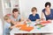 Young family drawing with colorful pencils