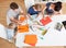 Young family drawing with colorful pencils