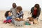 Young Family Enjoying Barbeque On Beach