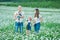 Young family in a field of flowers daises chamomile anjoy spa life happy together with cute faces in a village rustic motion