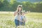 Young family in a field of flowers daises chamomile anjoy spa life happy together with cute faces in a village rustic motion