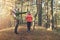 Young family on forest hike on sunny autumn day