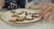 Young family having fun eating homemade cookies in the kitchen together close-up