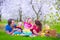 Young family with kids having picnic outdoors