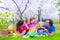 Young family with kids having picnic outdoors