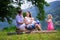 Young family with kids hiking at a lake