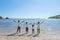 Young family lifting hands together on the beach