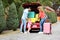 Young family loading suitcases in car trunk