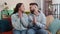 Young family marriage couple praying sincerely with folded arms asking God for help, begging apology