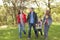 Young Family Outdoors Walking Through Park