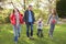 Young Family Outdoors Walking Through Park