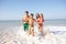 Young family play on beach