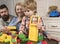 Young family playing with construction plastic blocks.