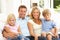 Young Family Relaxing Together On Sofa