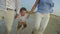 Young Family Running on the Beach