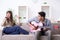 The young family singing and playing music at home